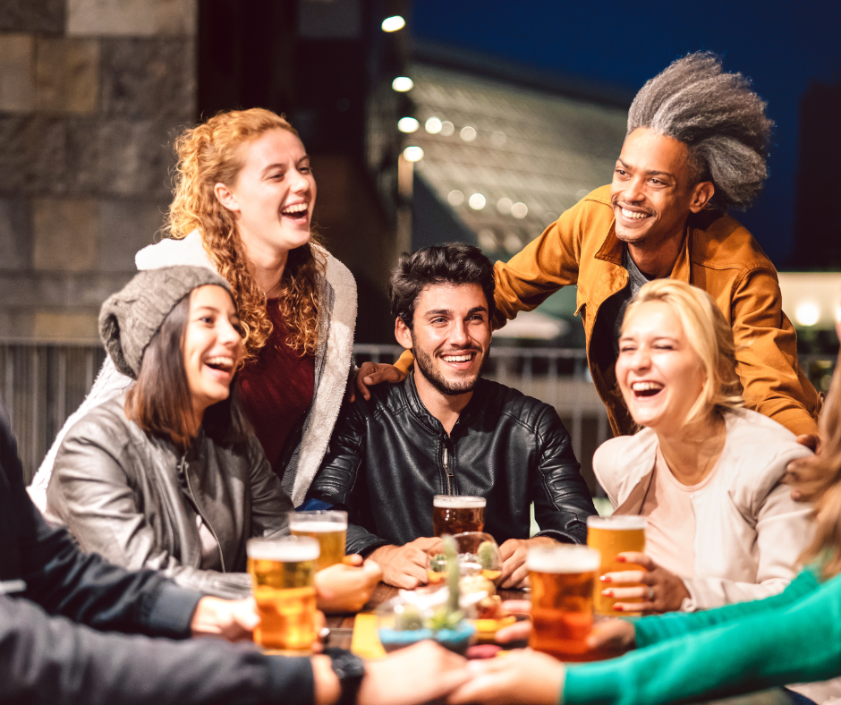 young people enjoying cocktails at outdoor cafe