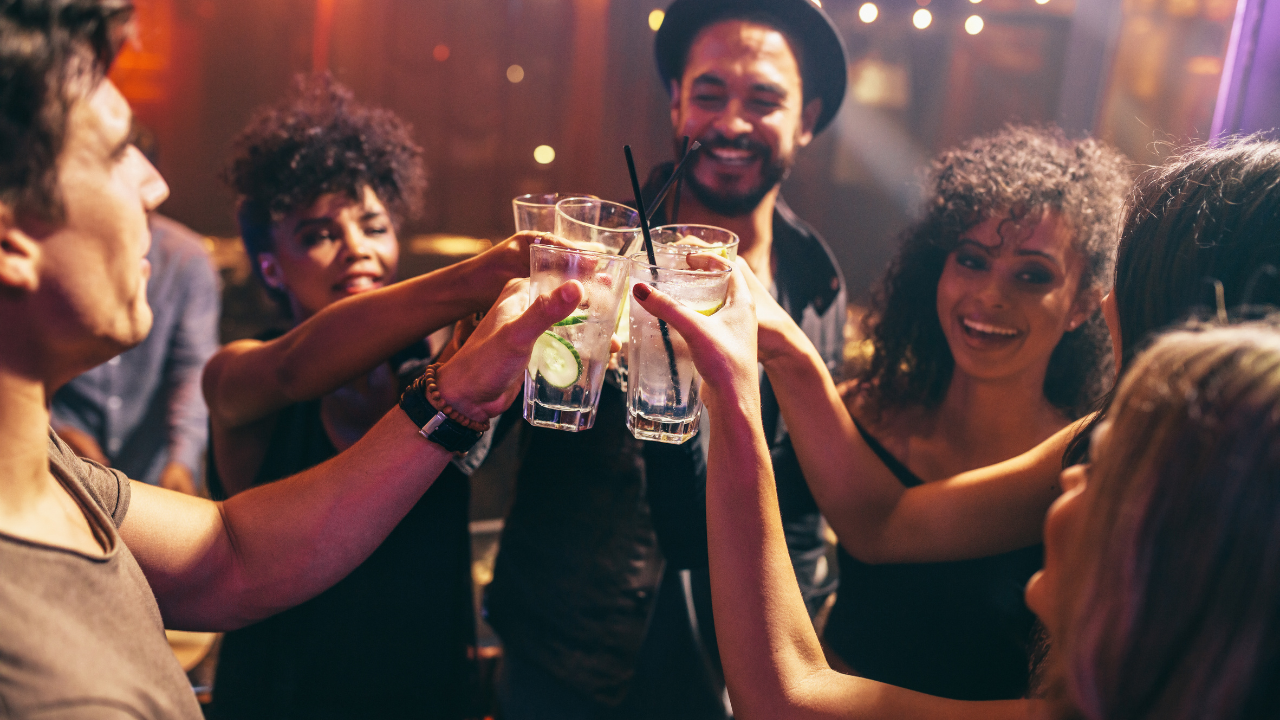 Friends toasting with cucumber water