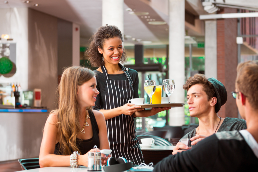 Server smiling with guests