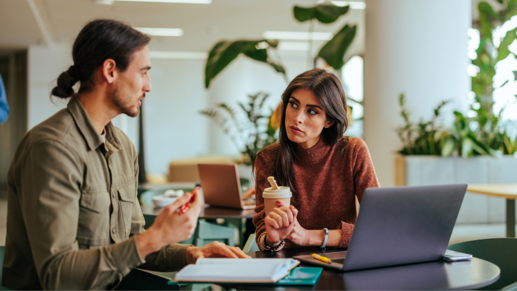 man and woman working remotely in restaurant